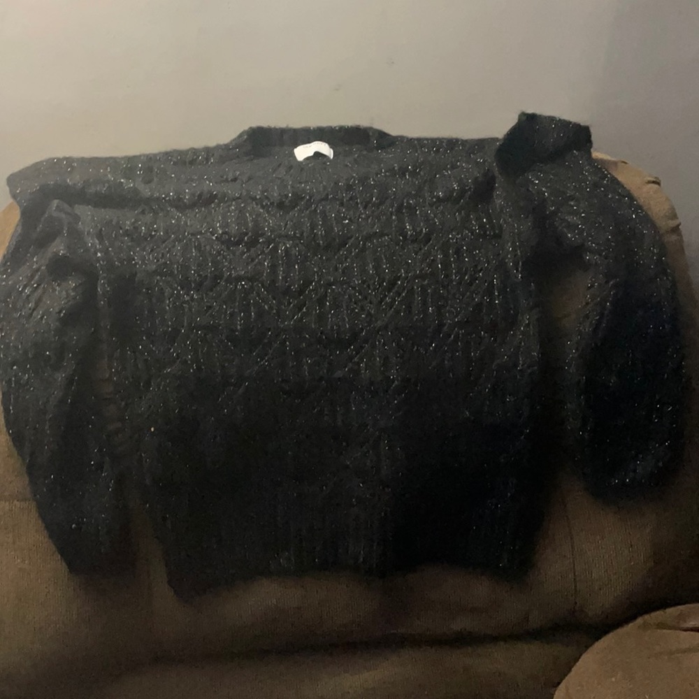 Black sweater with silver tinsel and ruffled shoulders